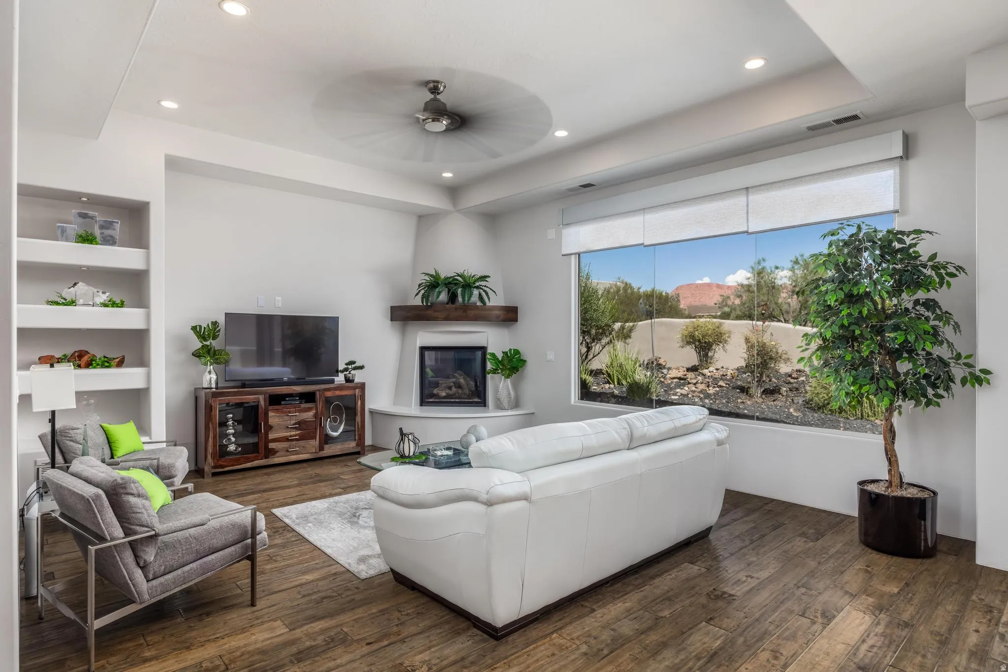 Recessed lighting, wood-finish flooring, corner fireplace with wood mantel, built-in shelving, and a large picture window