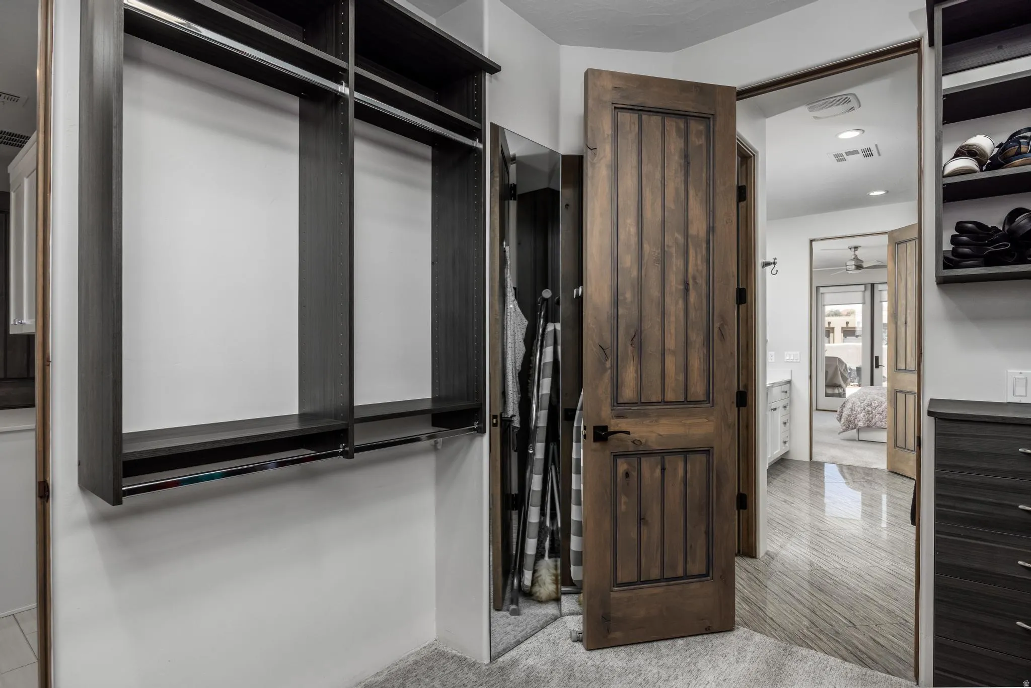 Built-in closet system with shelving and hanging rods. Primary Closet