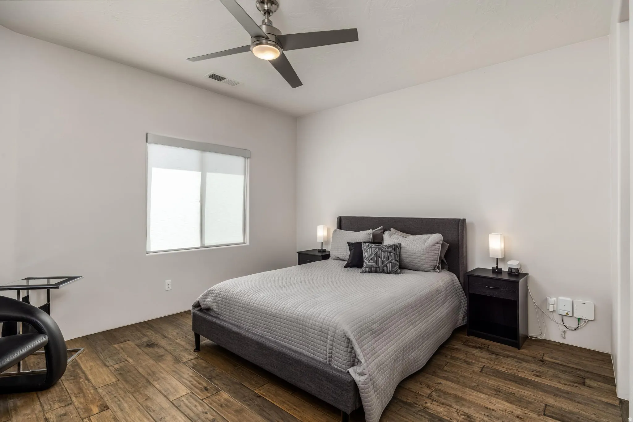 Wood-finish flooring, recessed lighting, and a contemporary ceiling fan
