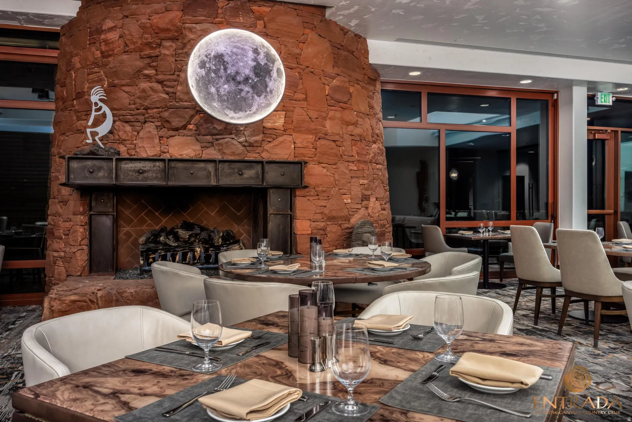 Stone fireplace with a dark metal mantel, recessed firebox, and decorative hearth