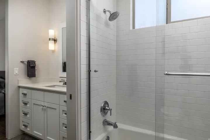 White subway tile shower surround with an integrated bathtub