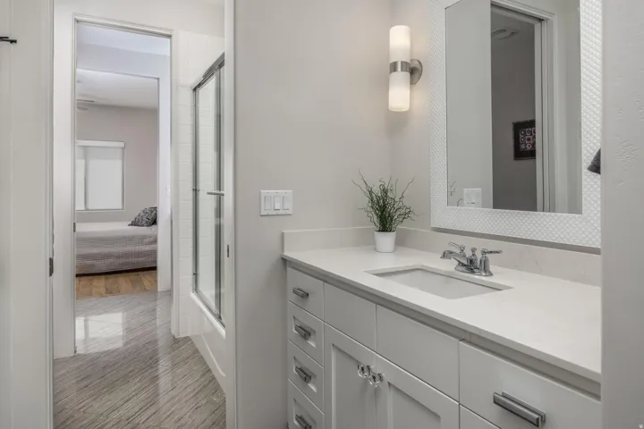 Bathroom with a vanity featuring a light-toned countertop, integrated sink, and cabinet storage