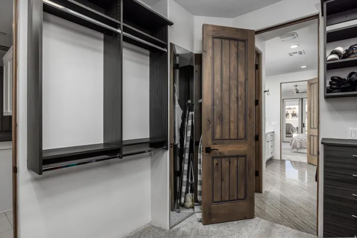 Built-in closet system with shelving and hanging rods. Primary Closet