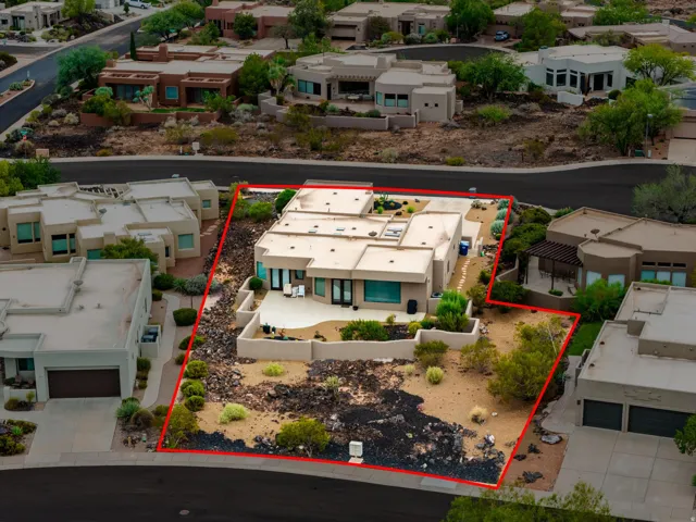 Contemporary stucco exterior with a flat roofline, integrated patio, and desert landscaping