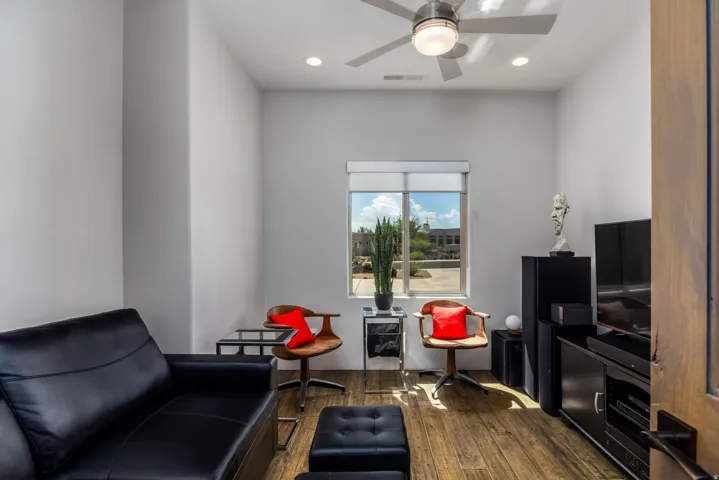 Wood-finish flooring, recessed lighting, and a ceiling fan with integrated lighting