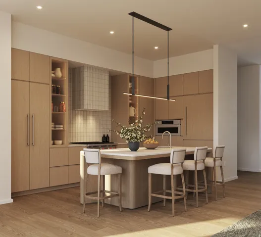 Kitchen featuring wood-finish cabinetry, integrated appliances, and a central island with countertop seating