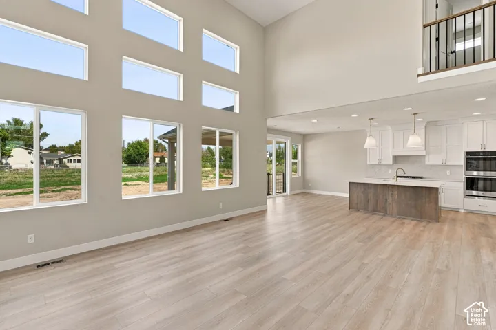 Soaring ceilings in the great room with abundant natural light