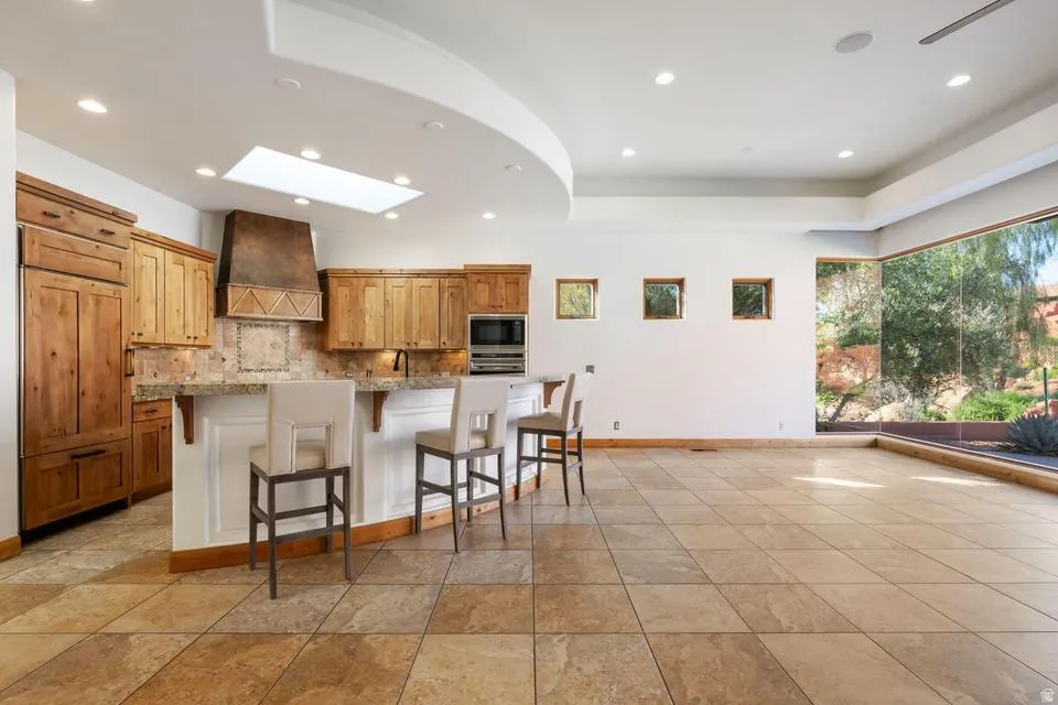 Kitchen featuring wood cabinetry, a skylight, and recessed lighting