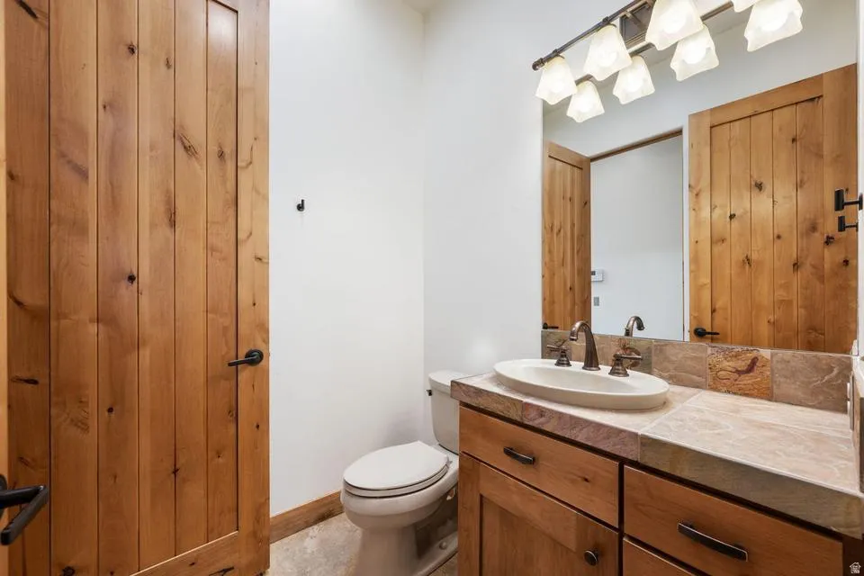 Wood-finish doors and cabinetry with dark hardware
