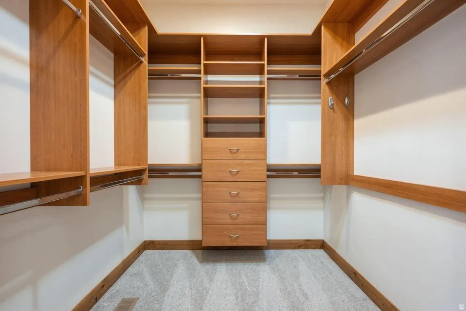 Built-in custom closet system with wood-finish shelving and hanging rods