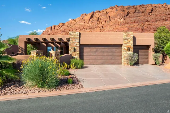 Stucco exterior with wood plank garage doors