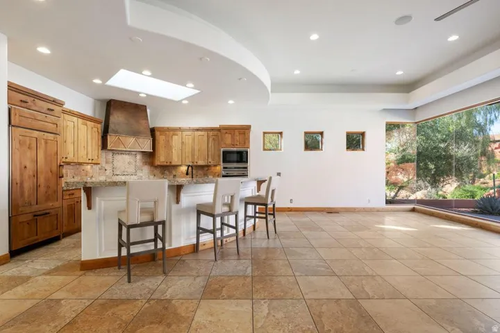 Kitchen featuring wood cabinetry, a skylight, and recessed lighting