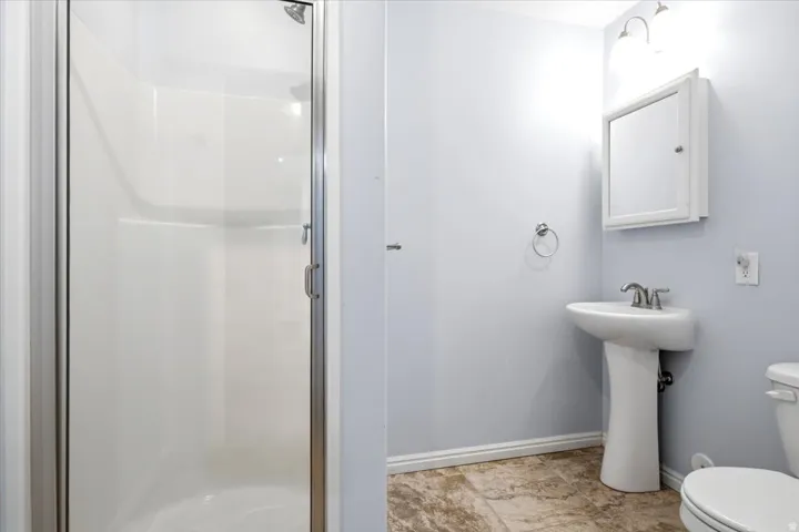 Walk-in shower with clear glass enclosure