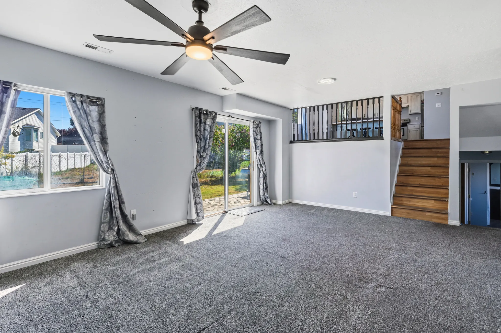 Recessed lighting, ceiling fan, and carpeted flooring