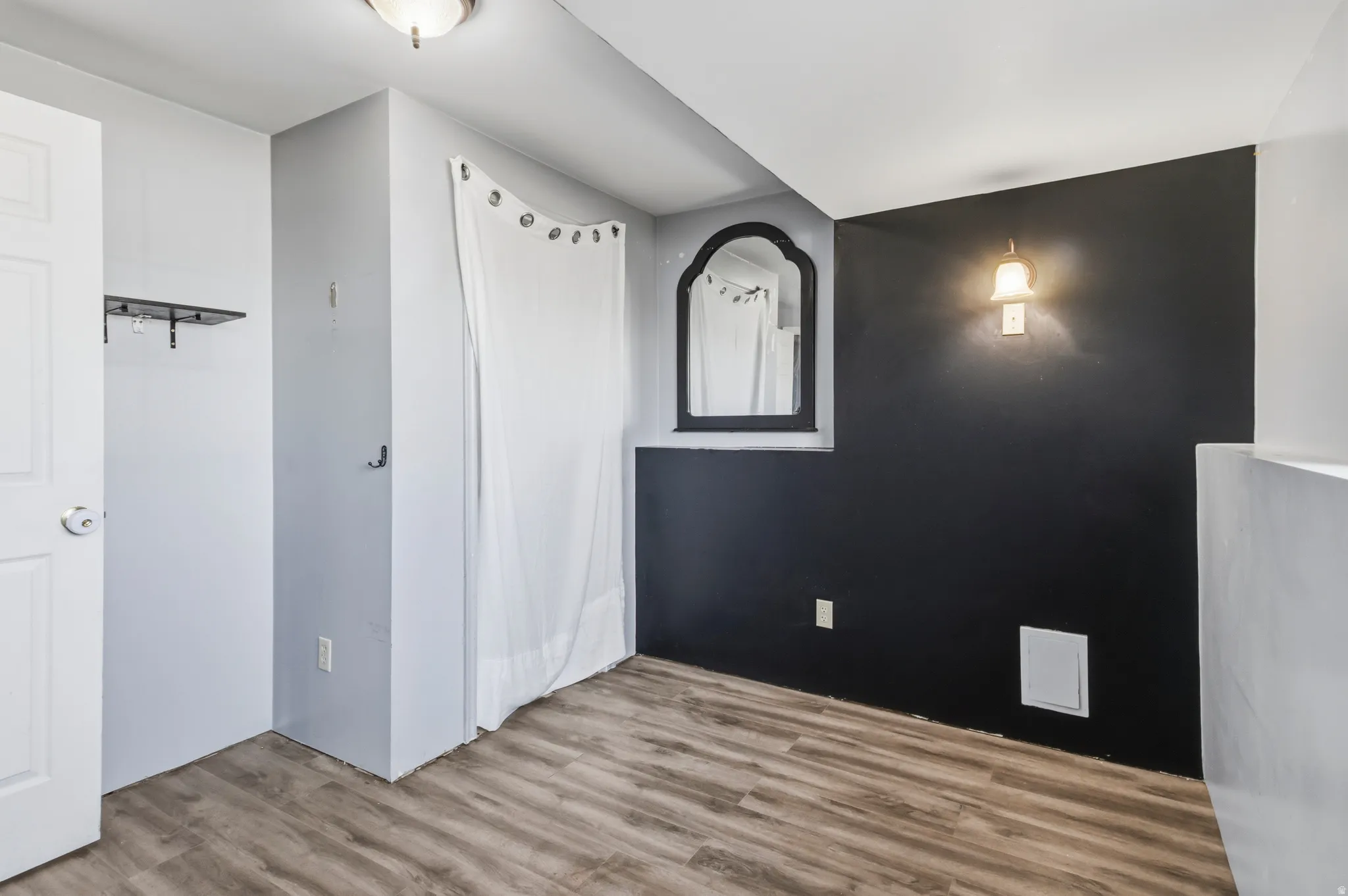 Wood-finish flooring, wall-mounted light fixture, ceiling-mounted light fixture, built-in shelf, wall mirror