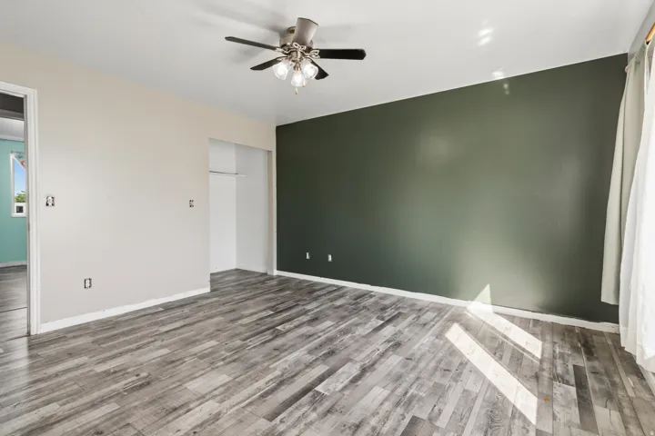 Wood-finish flooring with a multi-speed ceiling fan and light fixture