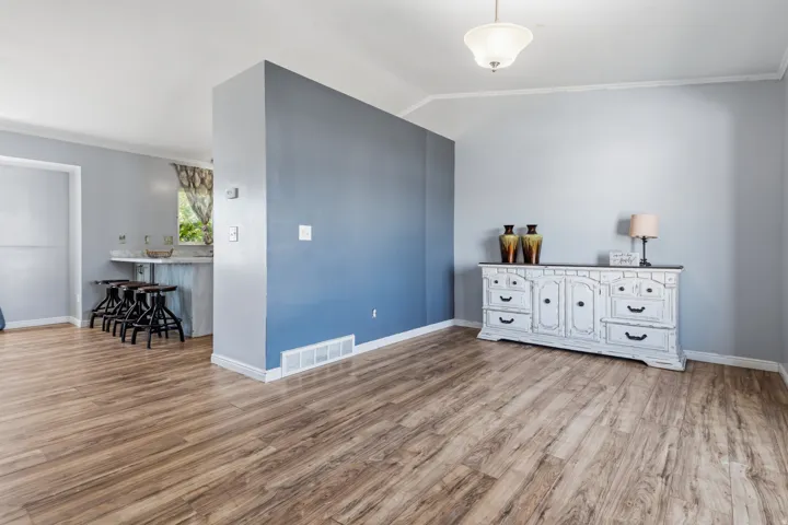 Wood-finish flooring throughout, vaulted ceiling, and recessed lighting