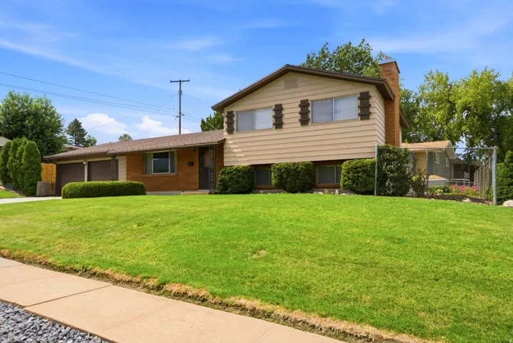 Front of home exterior split-level residence featuring brick and siding exterior