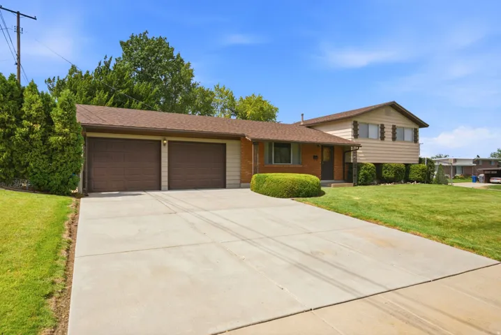 Front of home exterior with brick and siding exterior with a two-car garage