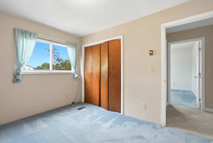Recessed ceiling lighting, light-toned wall paint, and a window with exterior scenery