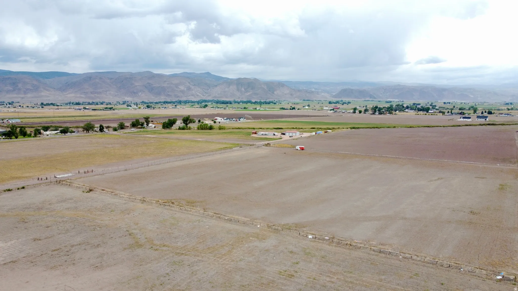 Expansive agricultural land featuring a rural setting and distant mountain range