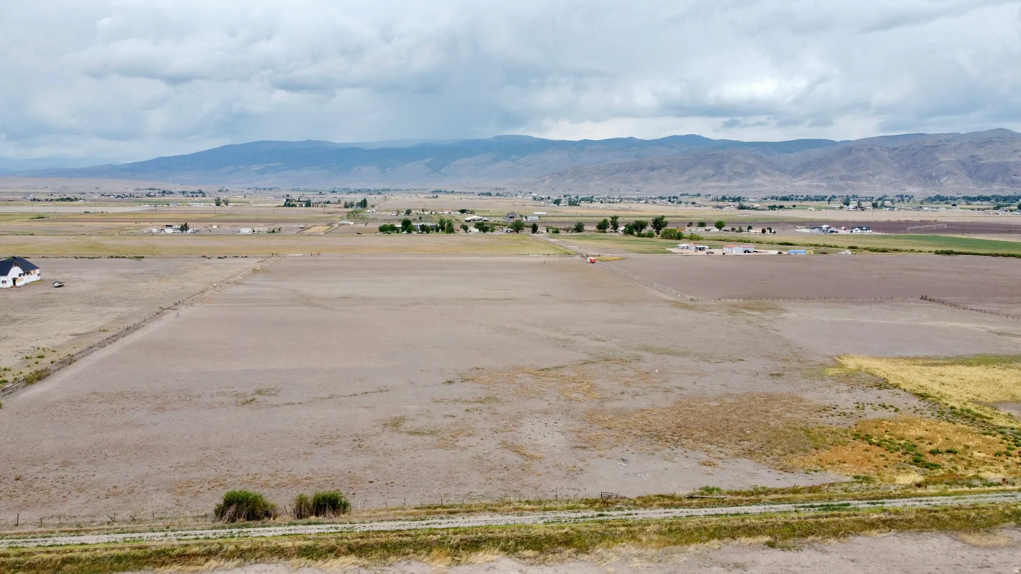 Expansive land parcel featuring open fields and distant mountain range