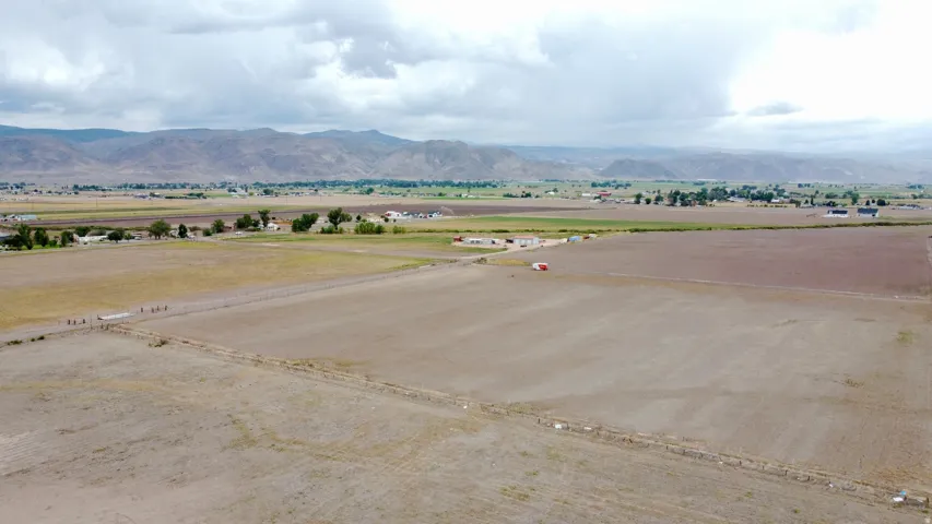 Expansive agricultural land featuring a rural setting and distant mountain range