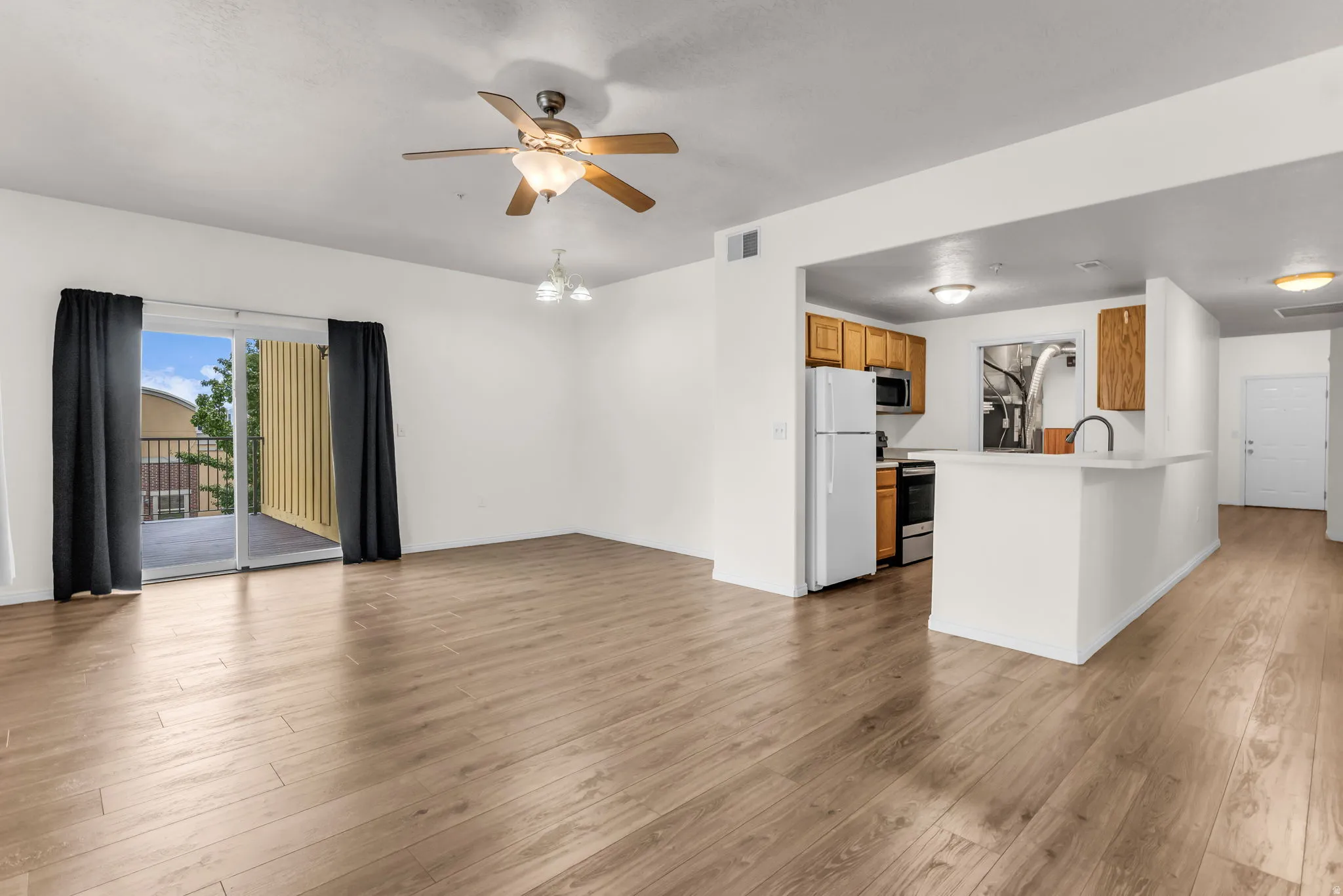 Open family room with wood laminate flooring