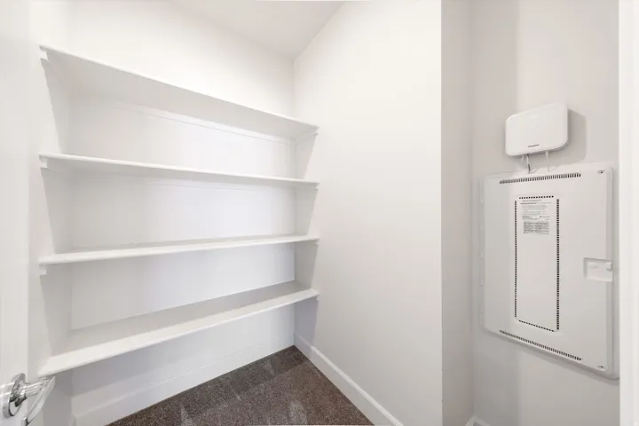 Built-in shelving with multiple levels and a chrome door handle