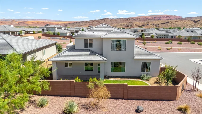 Two-story residence with a light gray exterior and a gray tile roof
