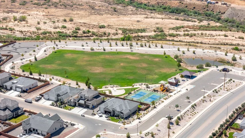Expansive community green space, two tennis courts, and a playground structure