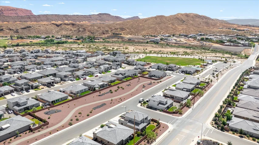 Residential neighborhood featuring paved streets, mature landscaping, and community green spaces