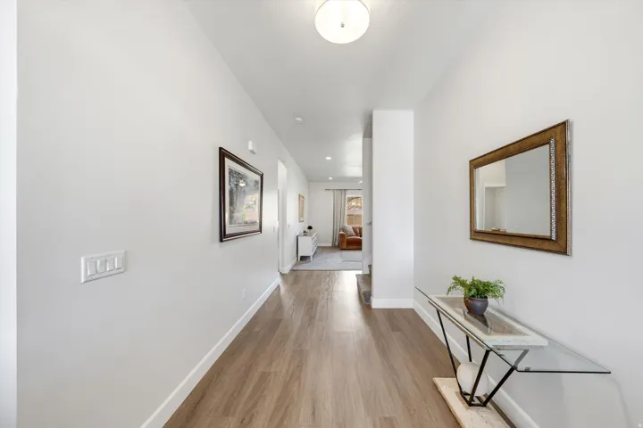 Wood-finish flooring throughout, complemented by light-toned wall finishes