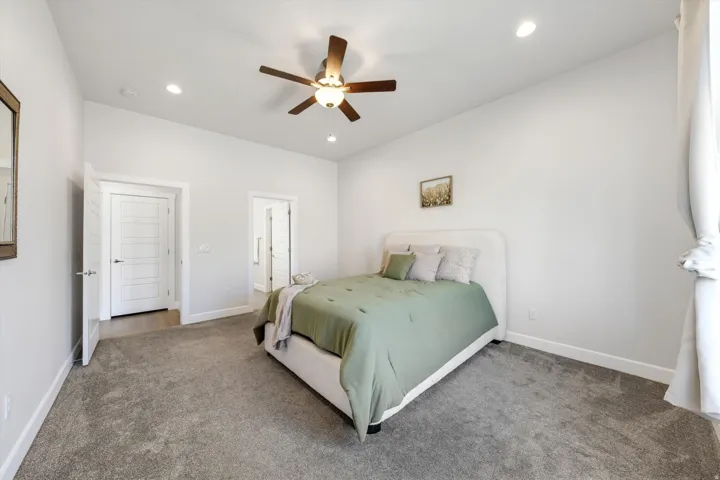 Vaulted ceilings, recessed lighting, ceiling fan, carpeting, and white trim throughout