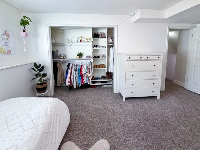 Recessed closet with built-in shelving and hanging rods