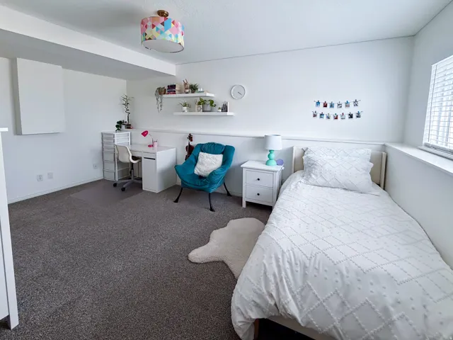 Carpeted flooring, built-in wall shelving, a window with blinds, and recessed lighting