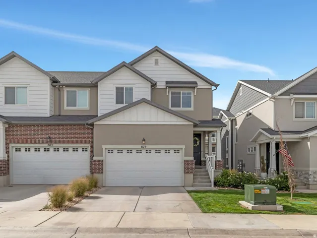 Two-story exterior with a combination of brick, stucco, and horizontal siding
