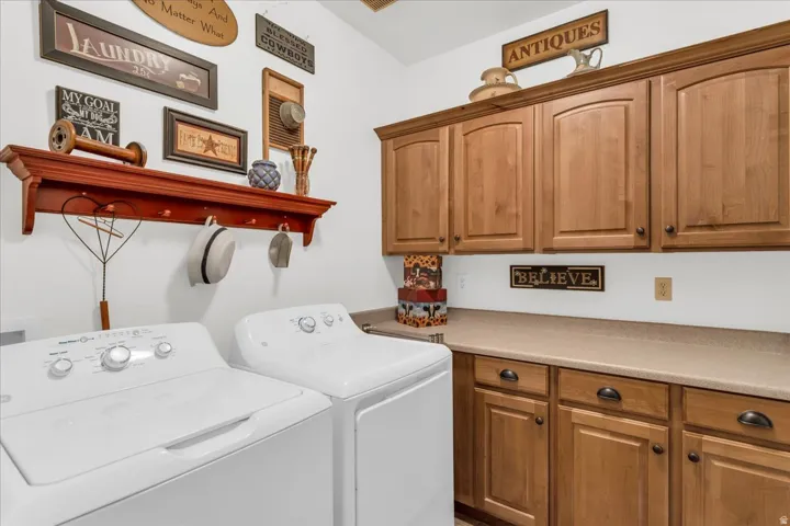 Wood-finish cabinetry with arched panel doors, stone-finish countertops, and under-cabinet storage