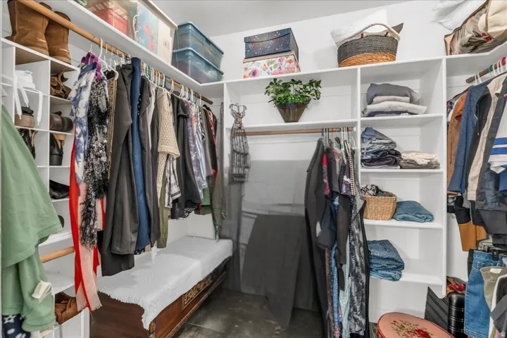 Custom closet system featuring multiple hanging rods, integrated shelving, and dedicated shoe storage