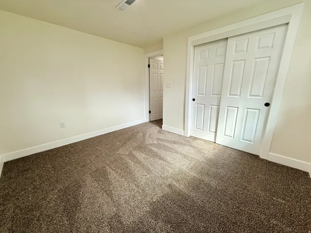 Wall-to-wall carpeting, light neutral wall paint, and white trim throughout