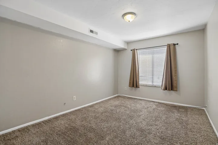 Neutral wall tones with textured carpeting