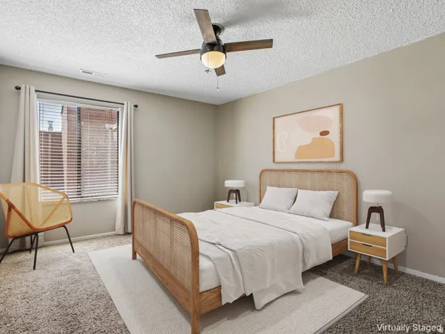 Textured ceiling with a ceiling fan, window with blinds, and neutral wall paint