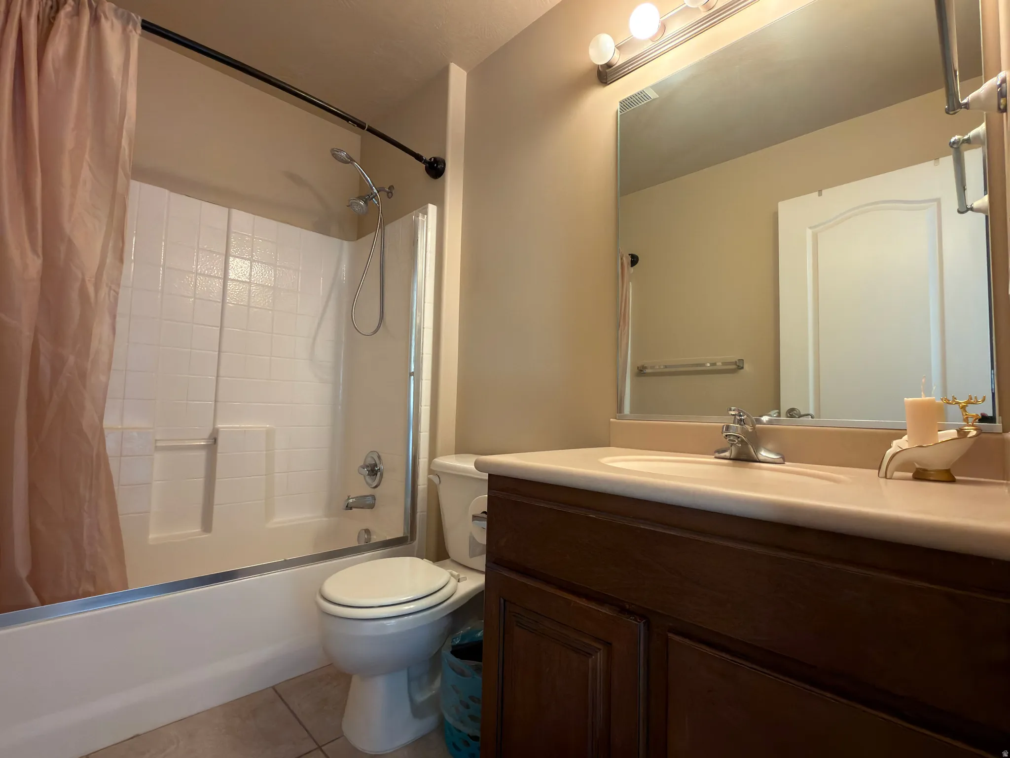 Built-in vanity with a single basin sink, mounted mirror, and overhead lighting fixture