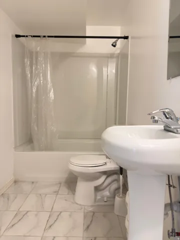 White pedestal sink with chrome faucet