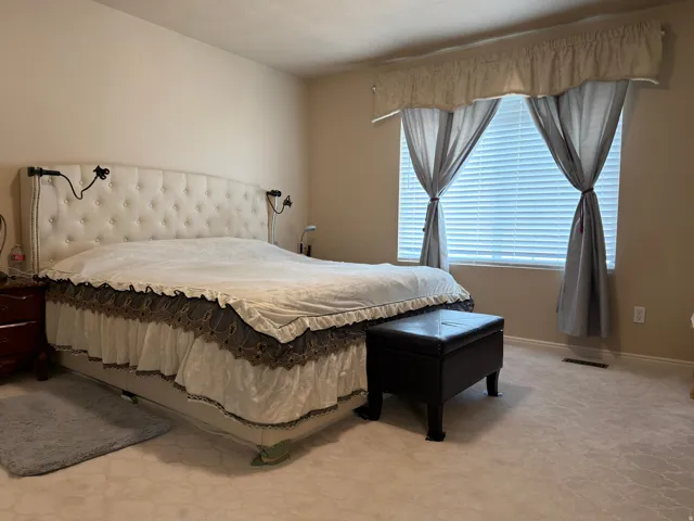 Plush carpet flooring complements neutral wall tones