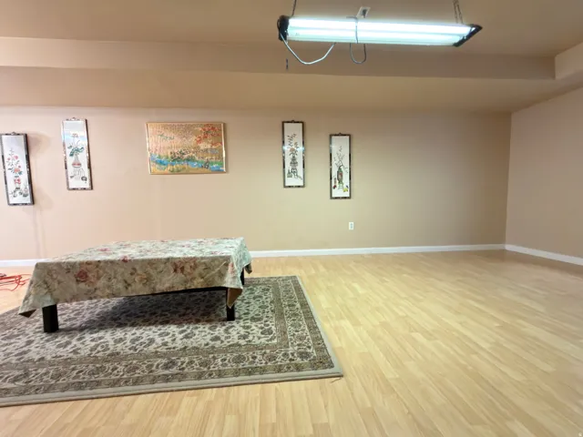 Smooth wood-finish flooring with light-toned walls
