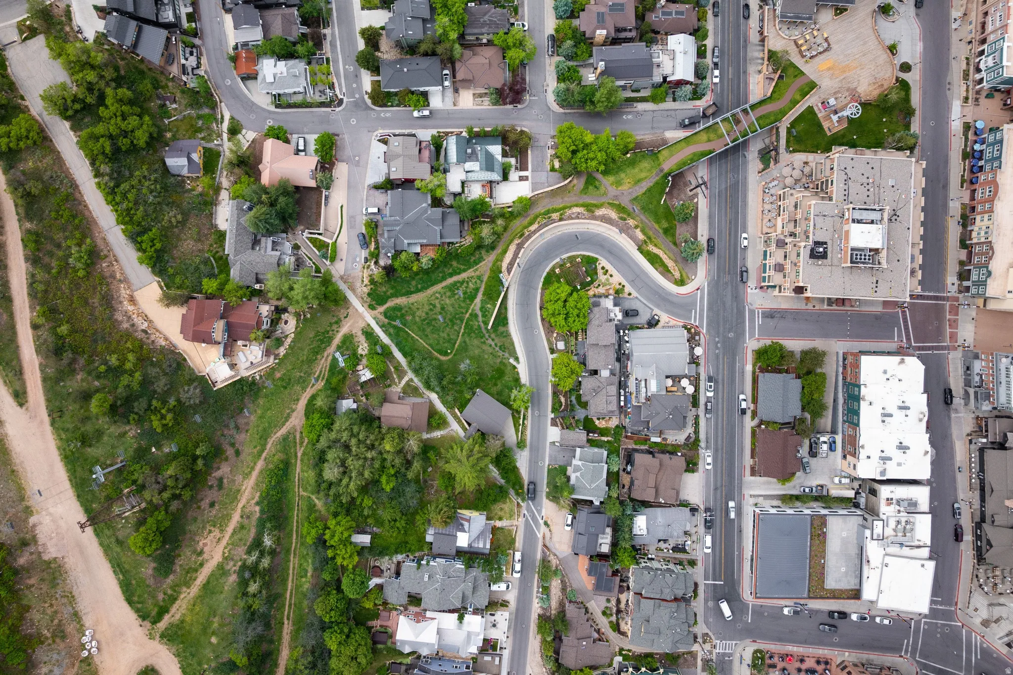 Aerial perspective showcasing the surrounding residential properties, public roads, and commercial structures
