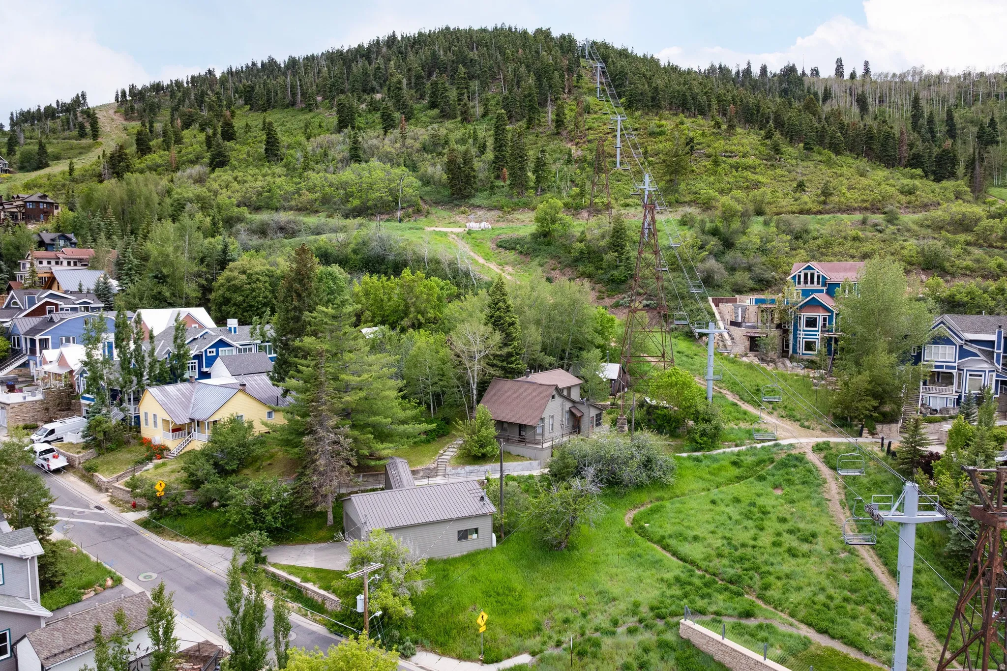 Hillside residences featuring varied architectural styles and mature trees