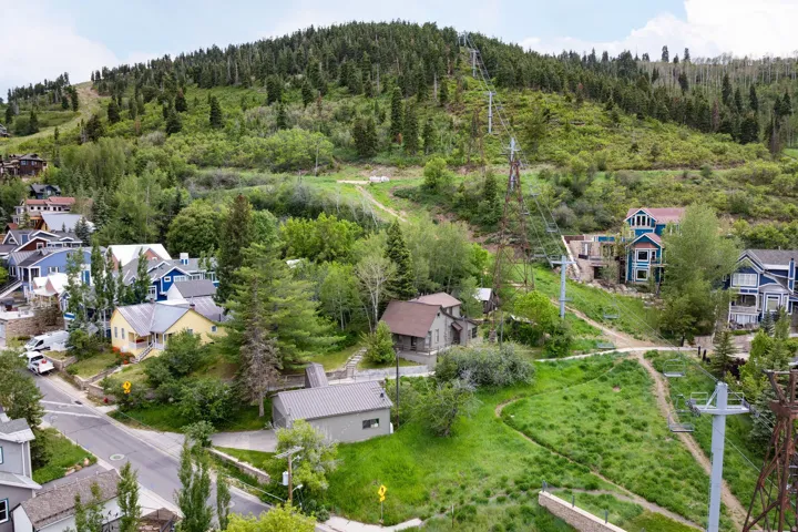 Hillside residences featuring varied architectural styles and mature trees