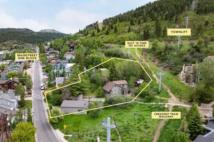 Aerial perspective highlighting property outline, surrounding residential structures, and extensive green space